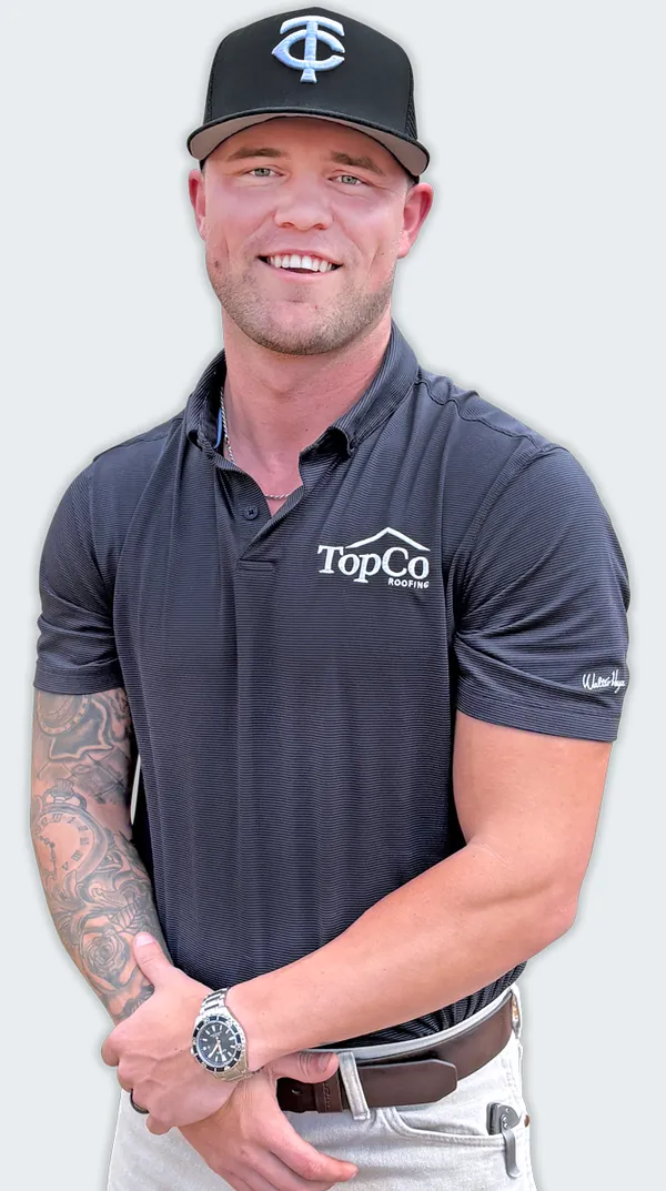 Dalton Baxley, owner of TopCo Roofing, in a TopCo polo and cap